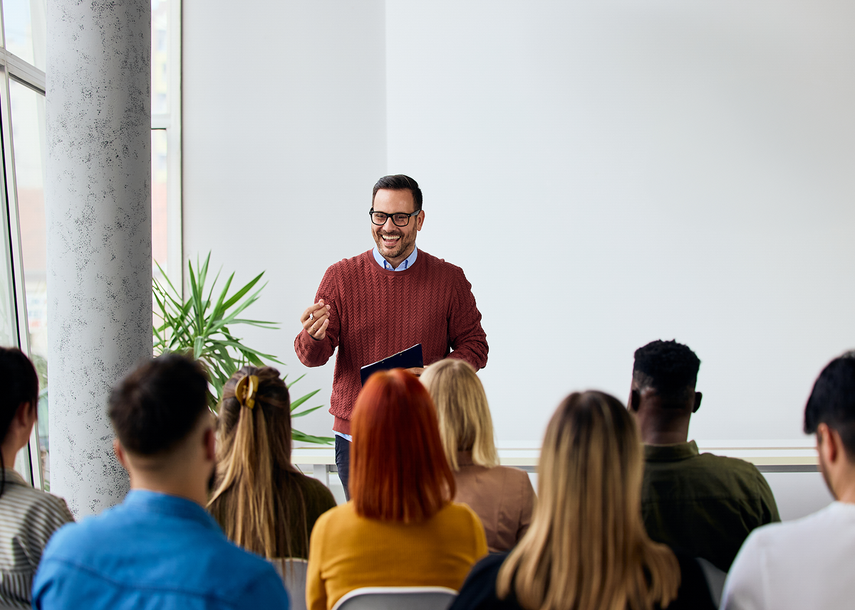 Man presenting to a group in classroom.