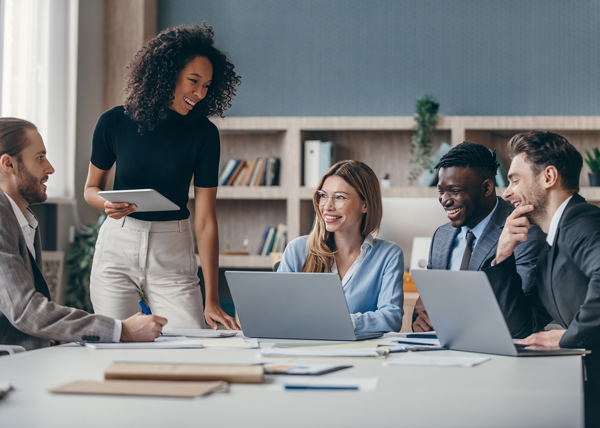 Colleagues smiling during an office meeting.