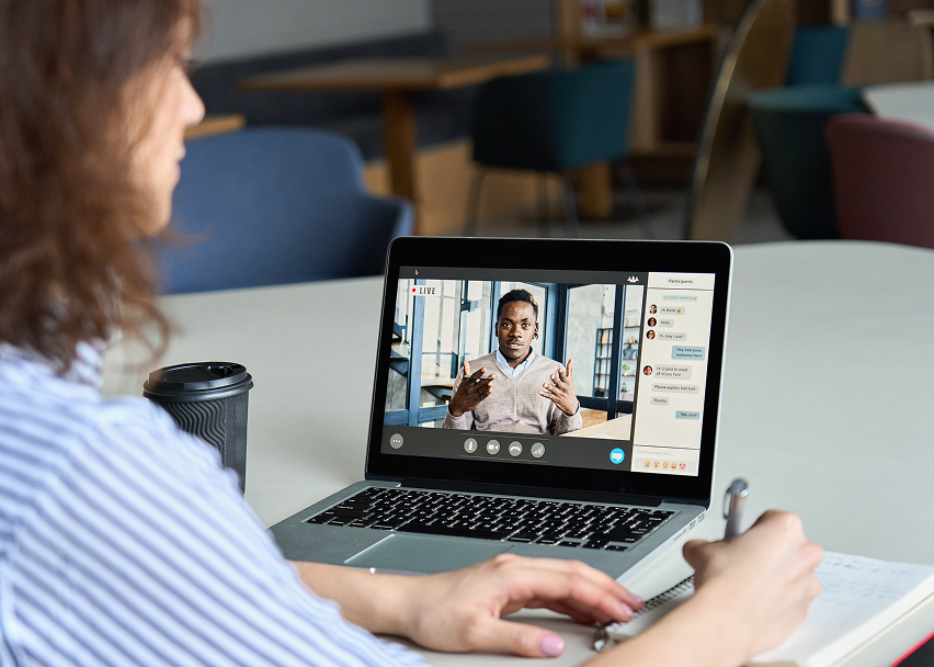 Person attending video call on laptop.
