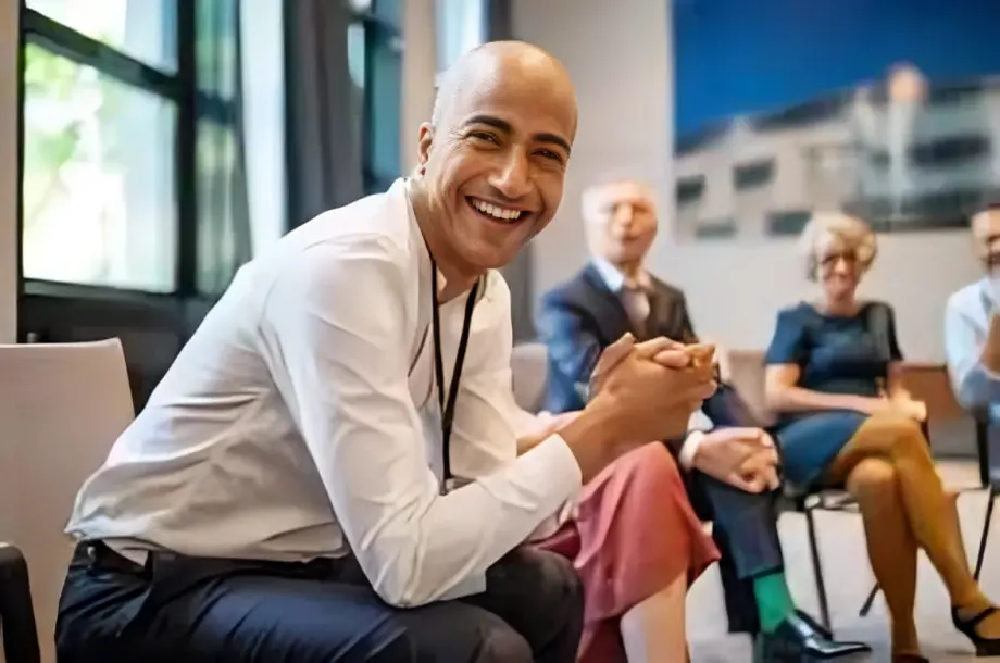 Smiling person in a business meeting setting.