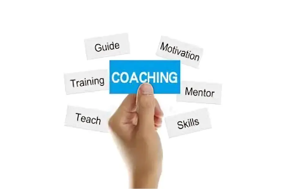 Hand holding "Coaching" card with related terms.