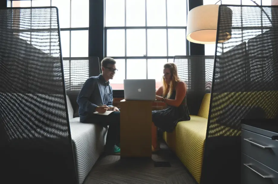 Two people collaborating in modern office space.