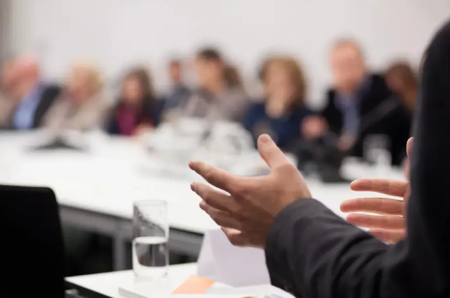 Person speaking at a business meeting.
