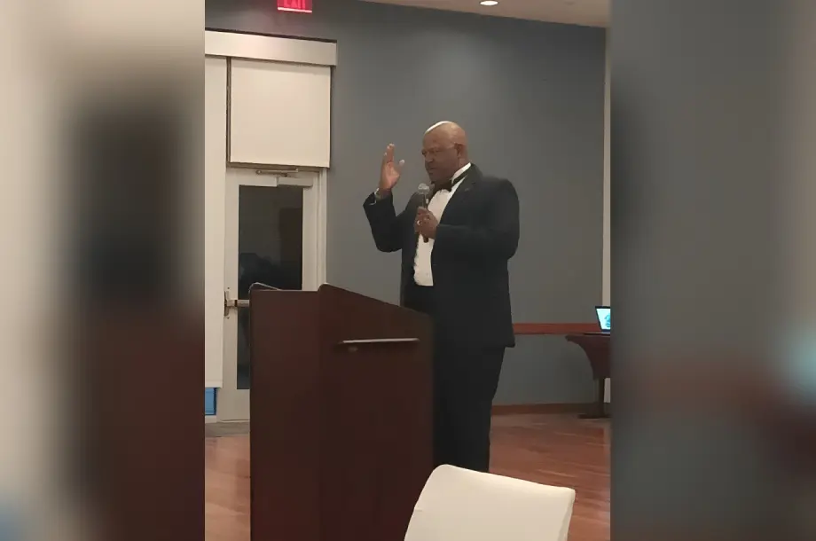 Man giving a speech at a podium.