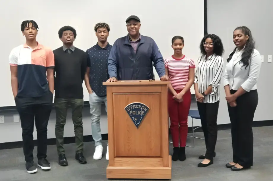 Group standing behind a police podium.